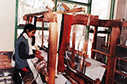 Lady weaving on a loom